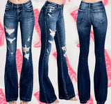 Distressed, mid rise, dark wash flared jeans